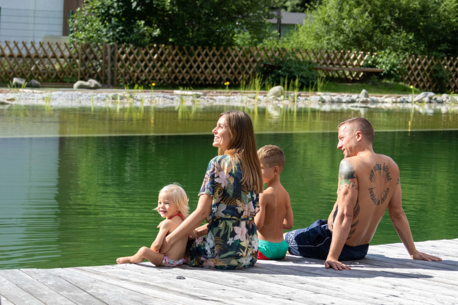 Relaxing at the swimming pond for the whole family at Alpenhof Naturglück in Filzmoos